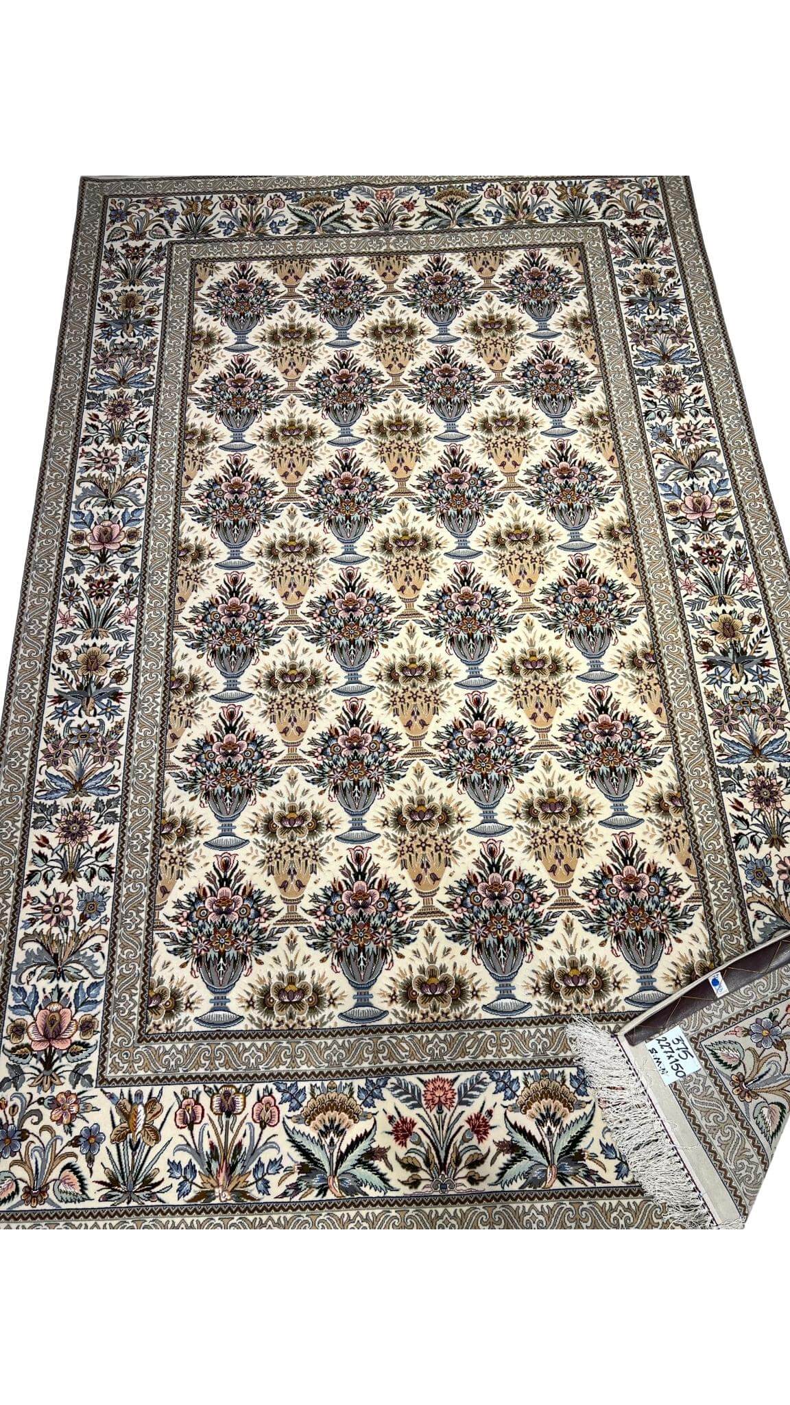 "Hand-knotted Persian rug in cream, blue, and pink tones from Isfahan"